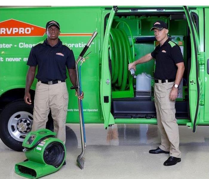 SERVPRO equipment van with two crew members getting out an air mover and an extractor
